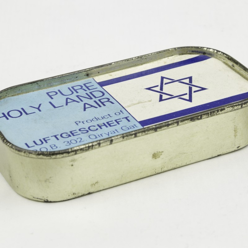 Rechteckige Metallbox mit abgerundeten Ecken, auf dem Deckel die Aufschrift 'PURE HOLY LAND AIR' und ein Davidstern, Produkt von Luftgescheft