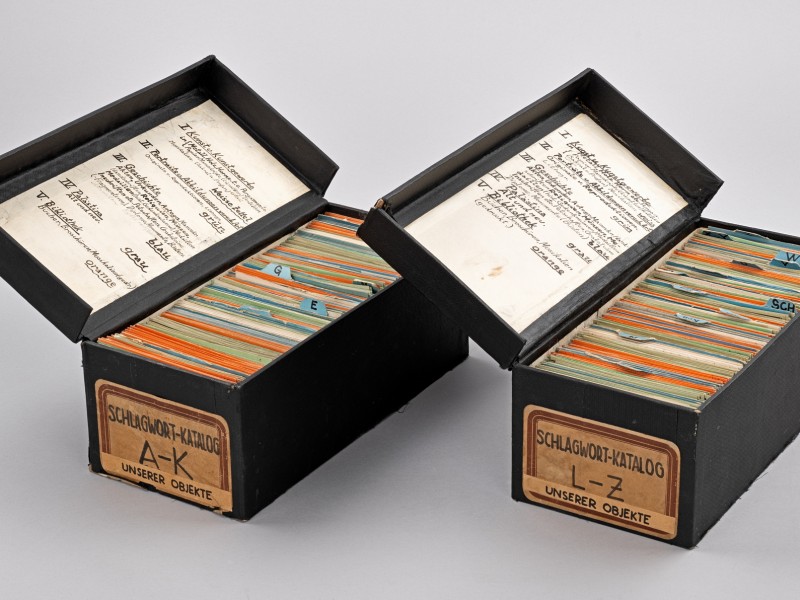 Two black boxes filled with colorful index cards