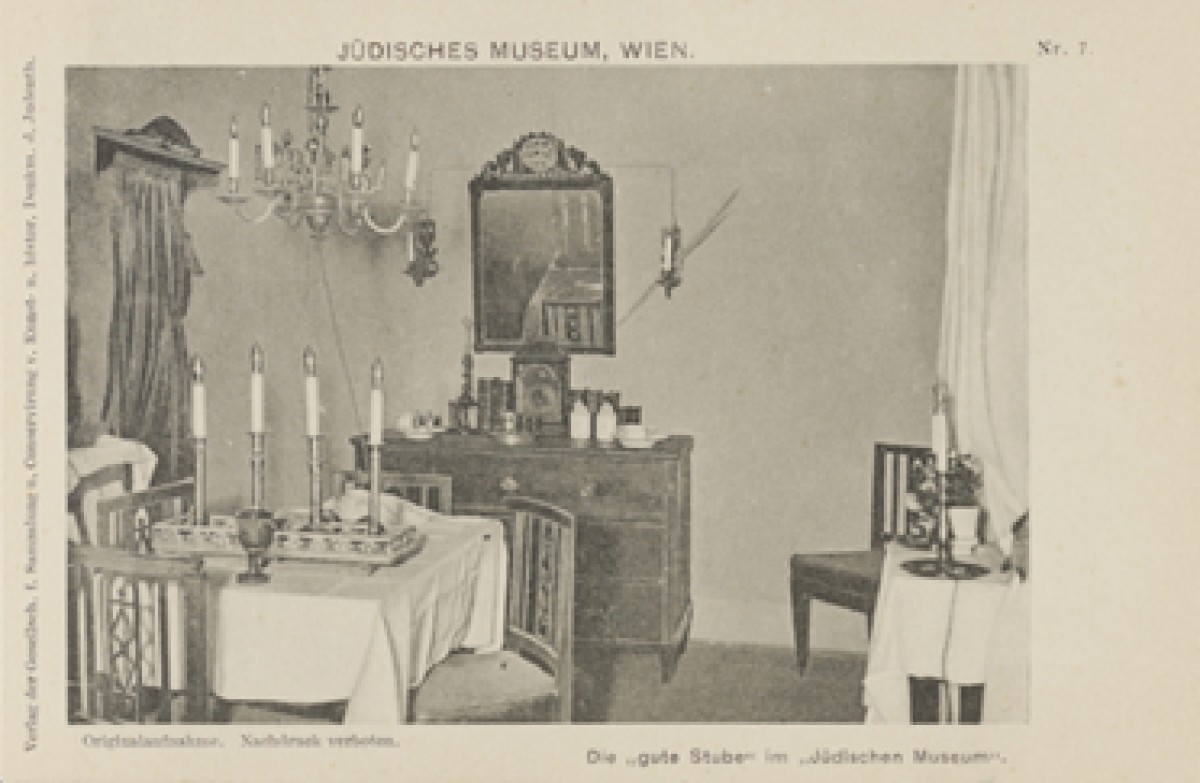 : Picture postcard of a period room decorated for shabbat that was featured as a museum display